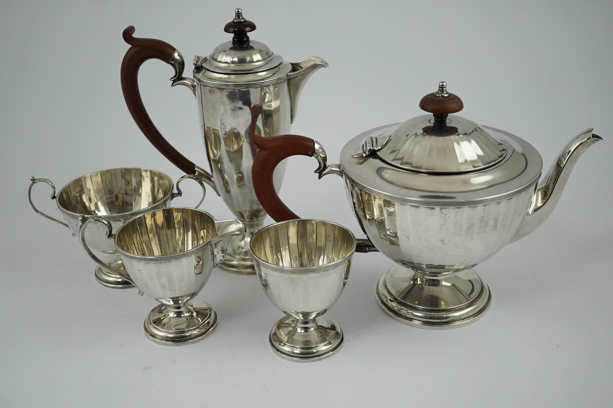 A George V panelled silver five piece tea set by Adie Brothers